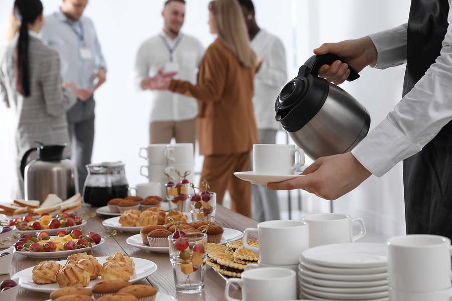 waitress pouring hot drink during coffee break, closeup